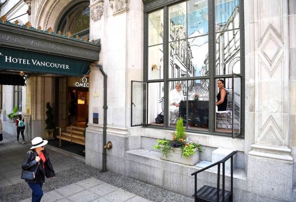 People Are Walking Into A Window Display To Drink Tea In Vancouver